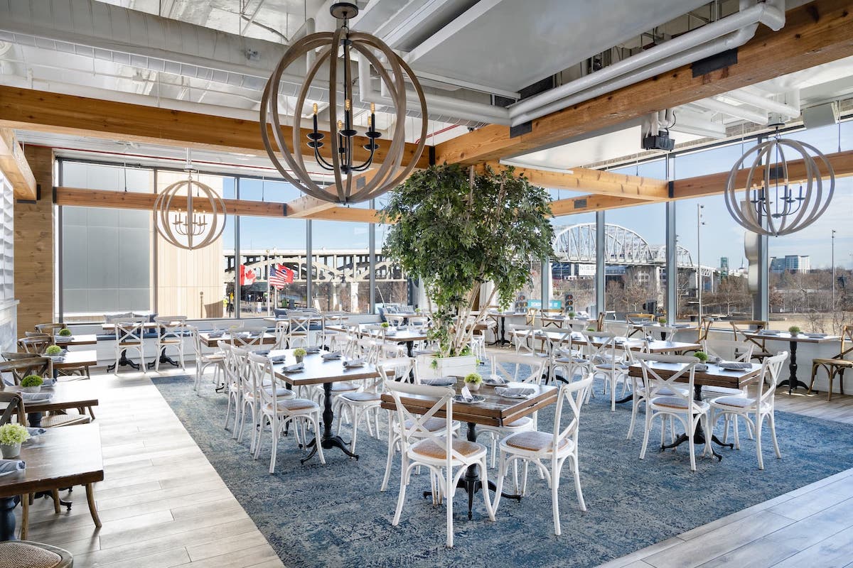 Light pours through large windows at Hampton Socials restaurant