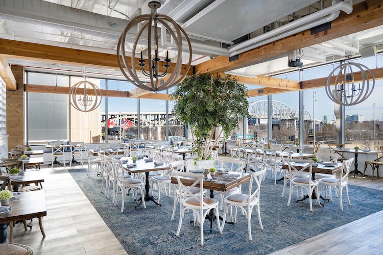 Light pours through large windows at Hampton Socials restaurant