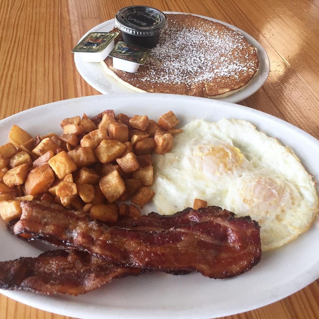 Bacon and pancakes on a plate at Fenwicks 300