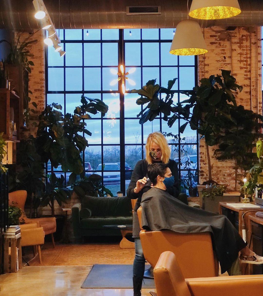 Alchemist stylist giving a haircut and interior