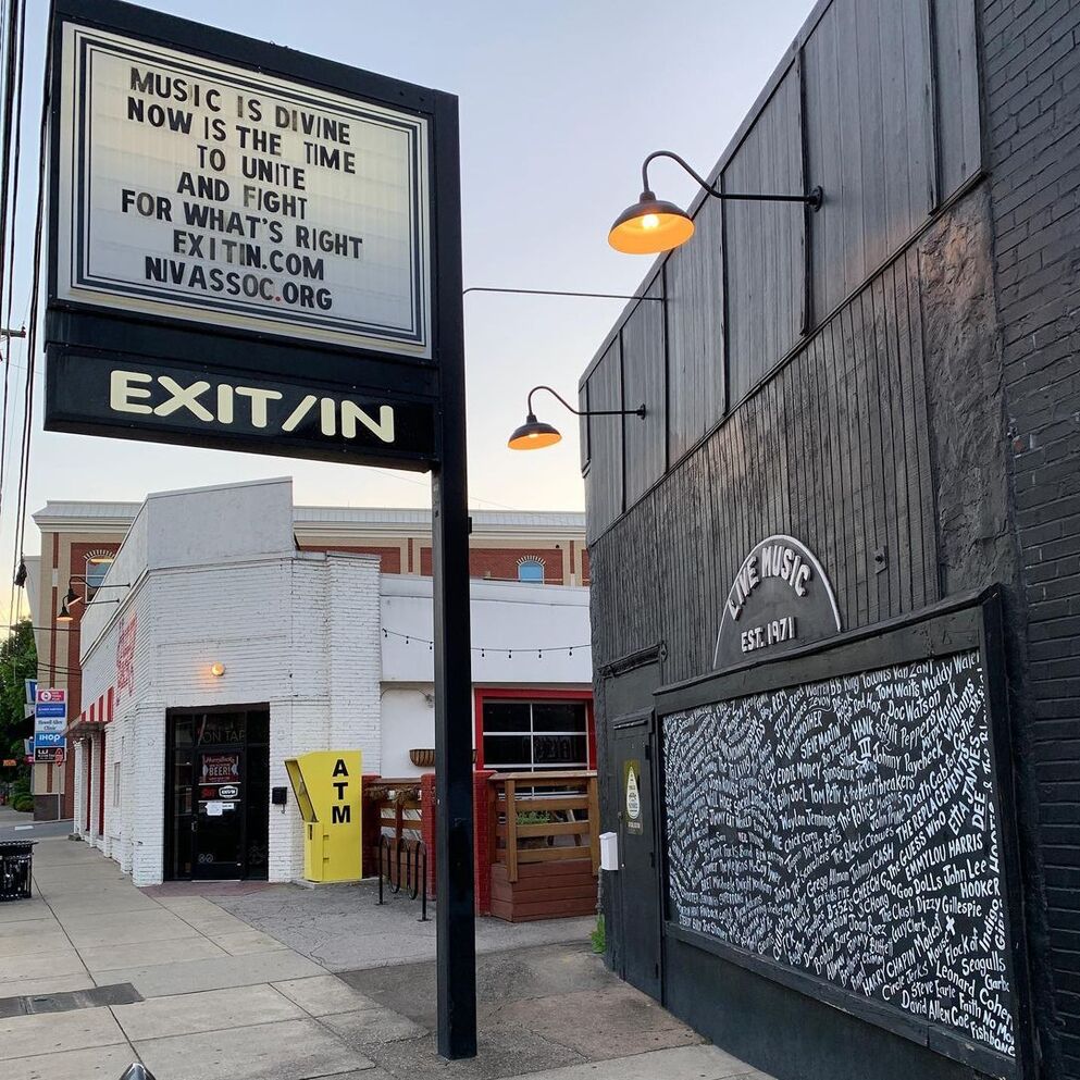 EXIT/IN outside sign and wall