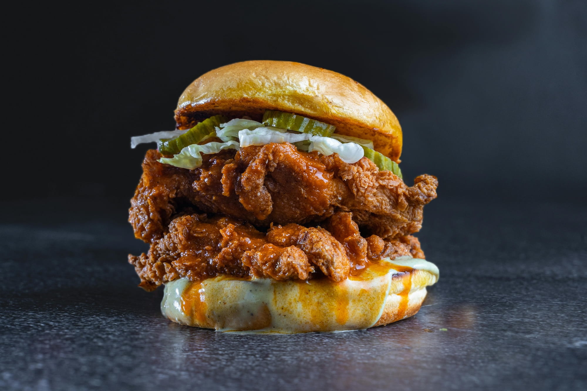 A hot chicken sandwich with mac and cheese