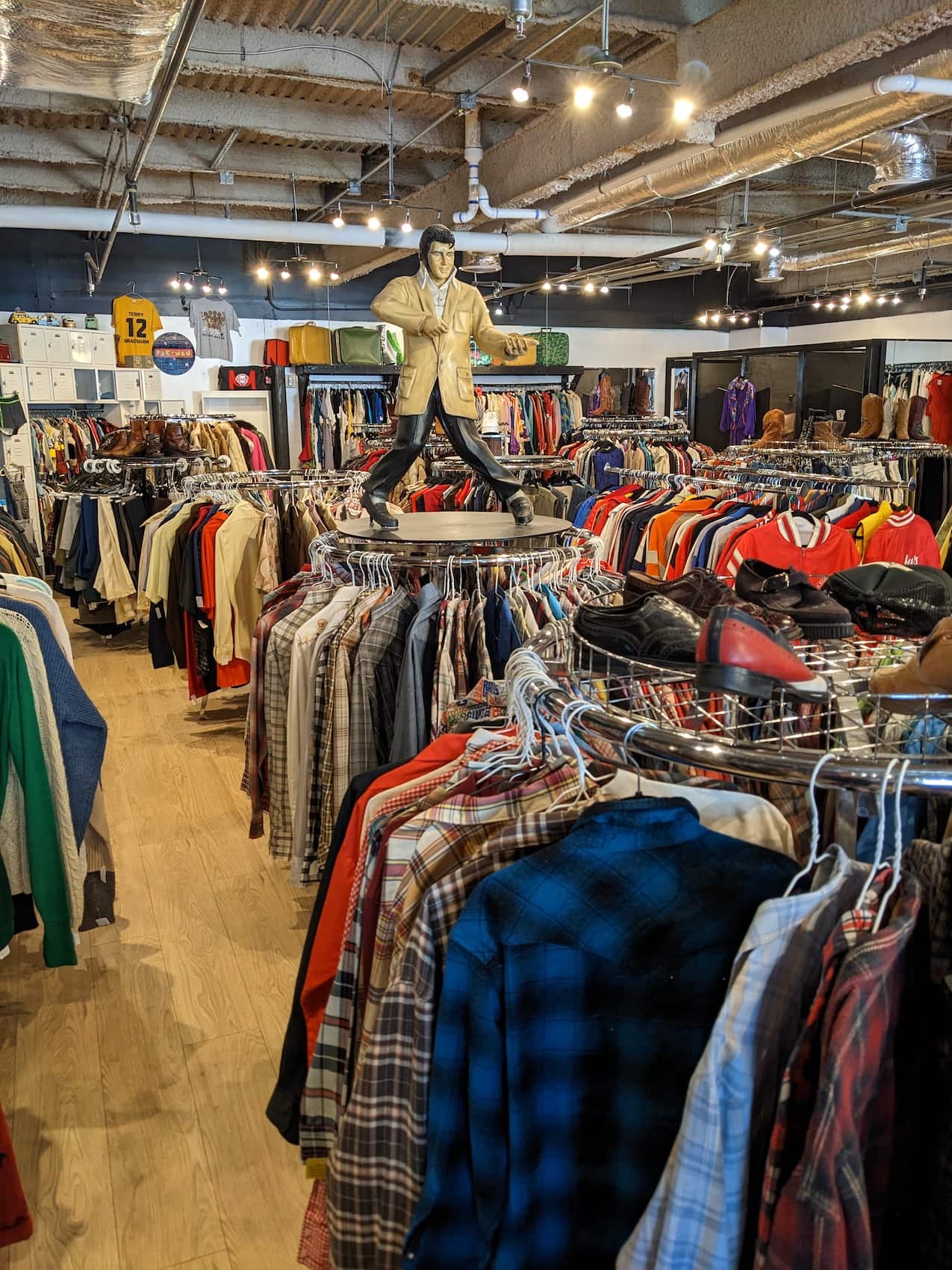 Star Struck Vintage Elvis statue and lots of clothes on circluar racks