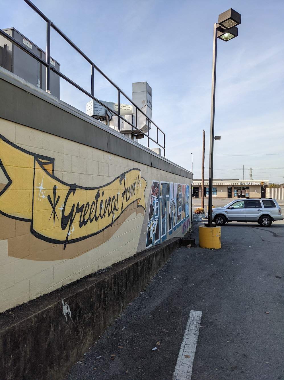 "Greetings from Athens" mural and street view