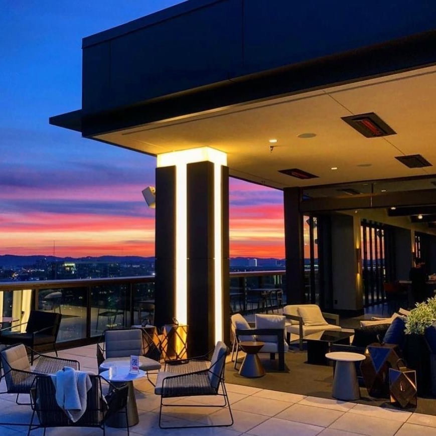 A modern rooftop bar at sunset