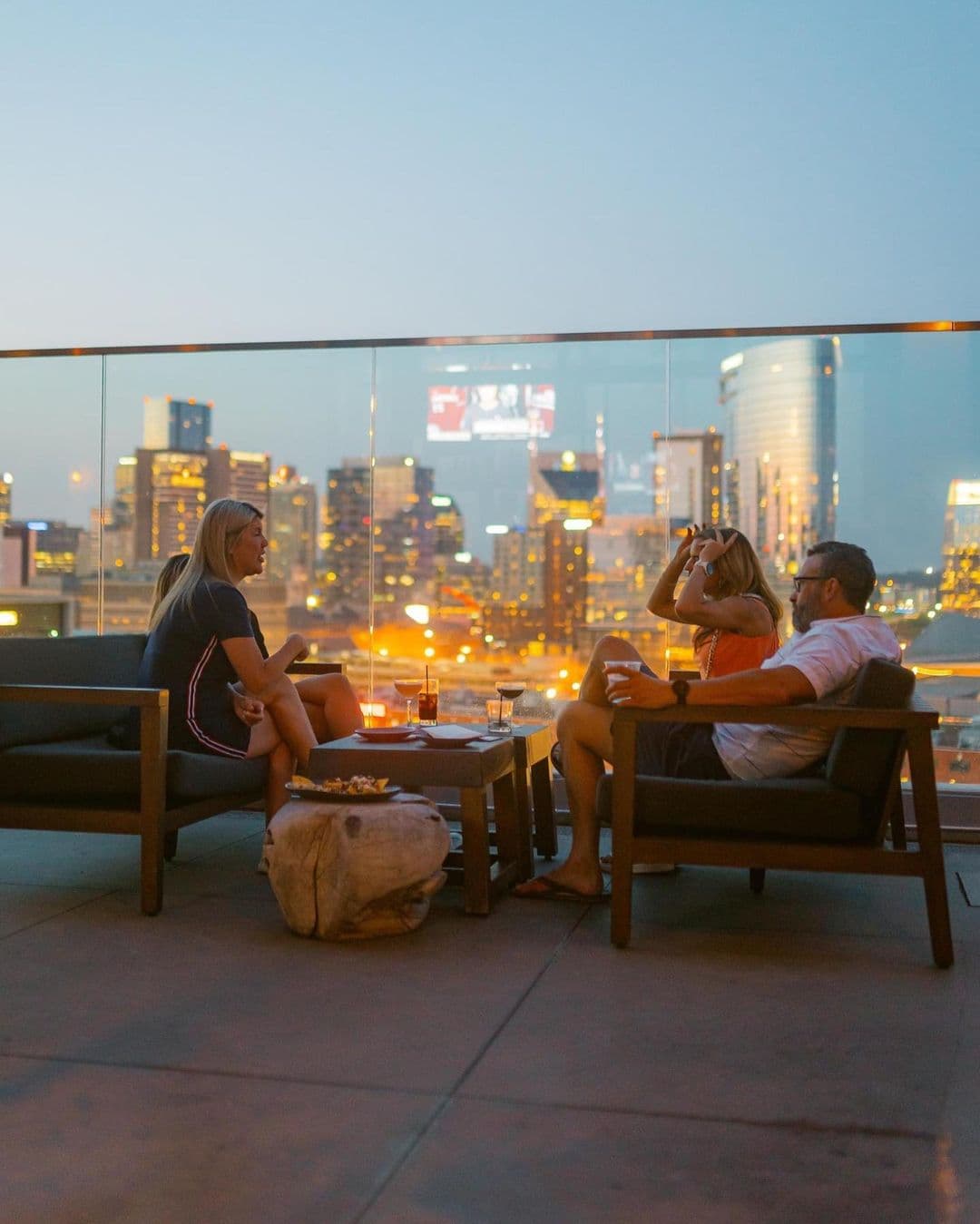 Couples looking out on downtown Nashville from Proof rooftop bar