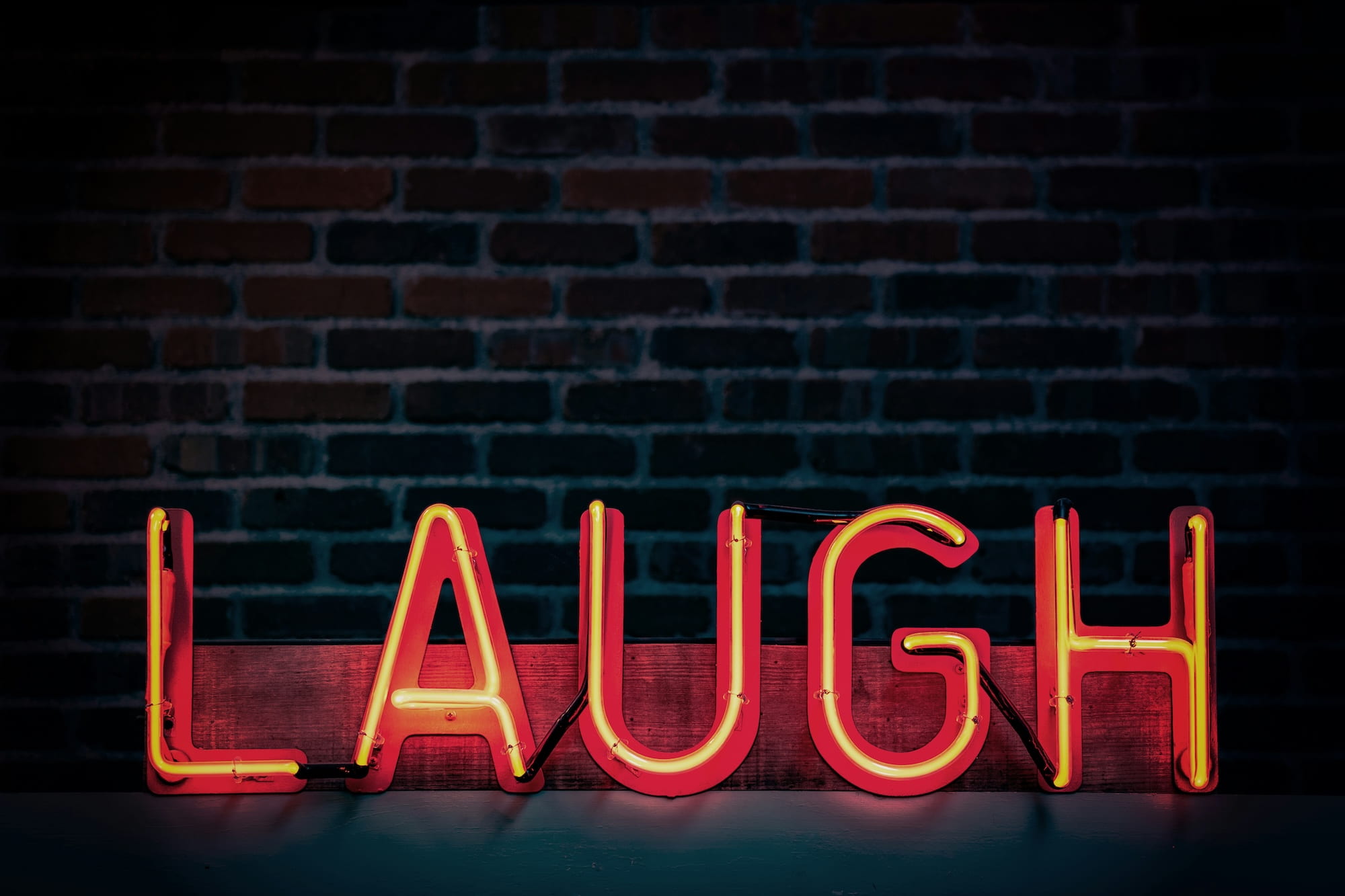 A sign that says laugh