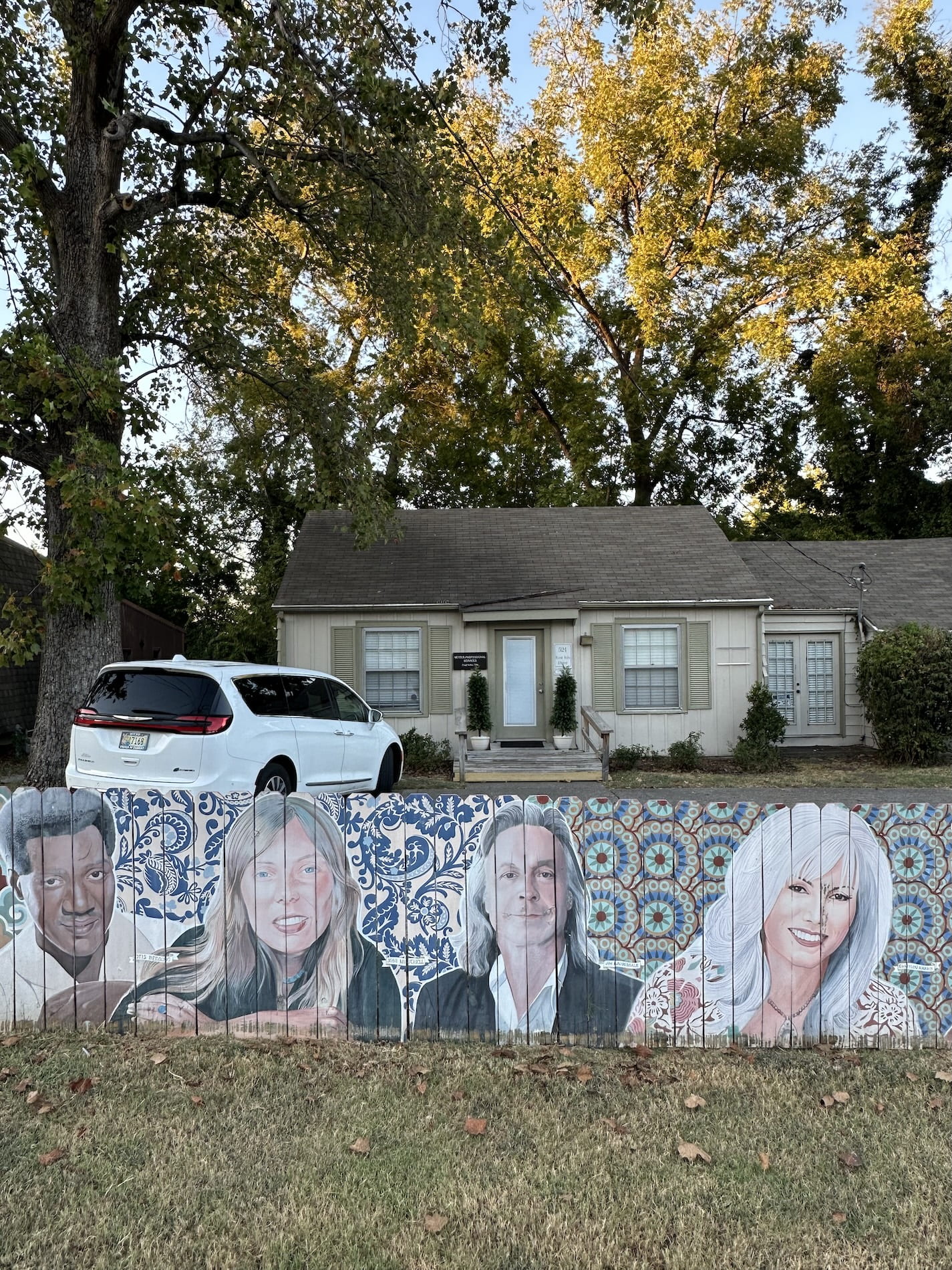 A fence mural of country stars and a house