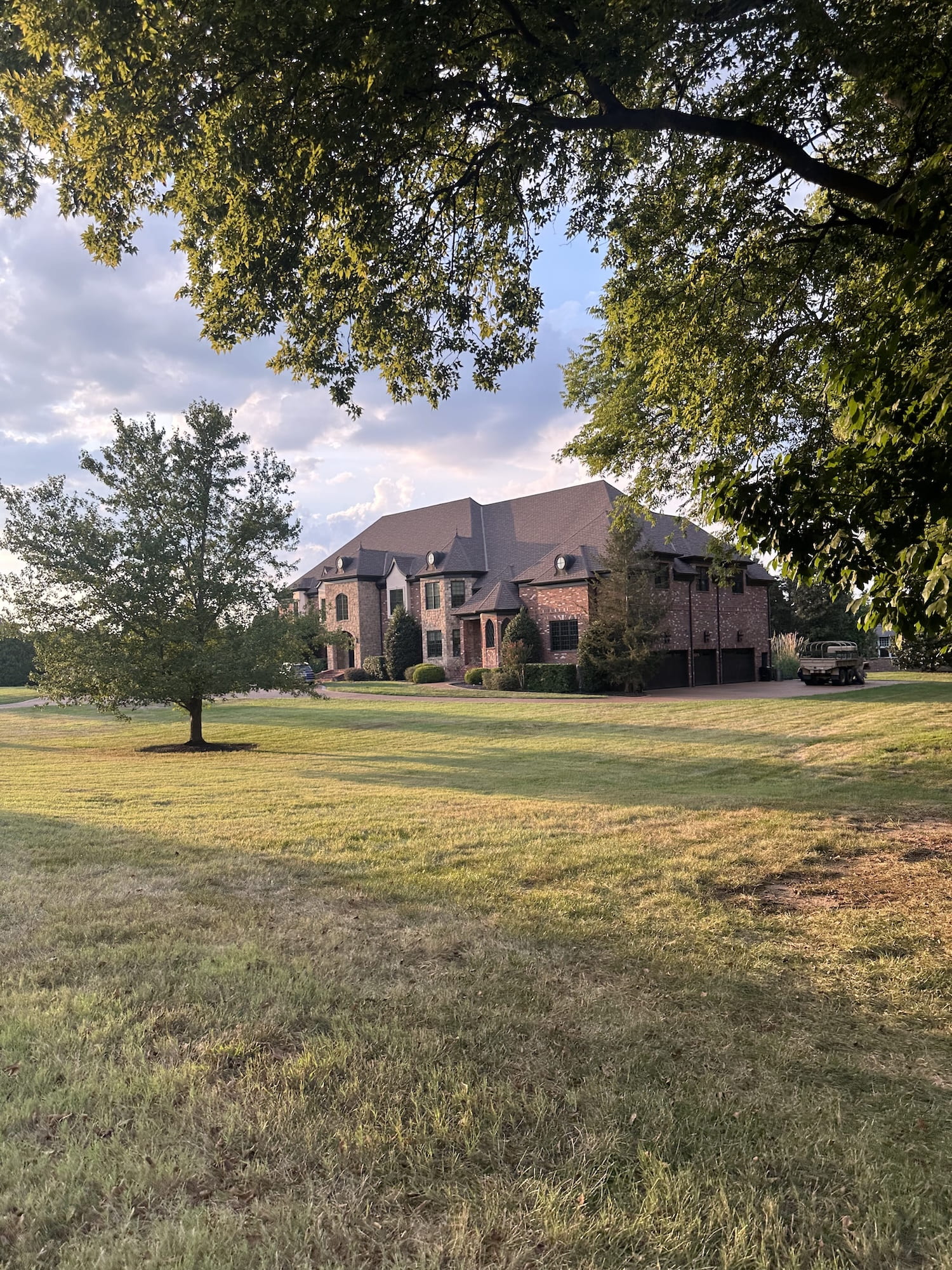 A brick mansion and big trees