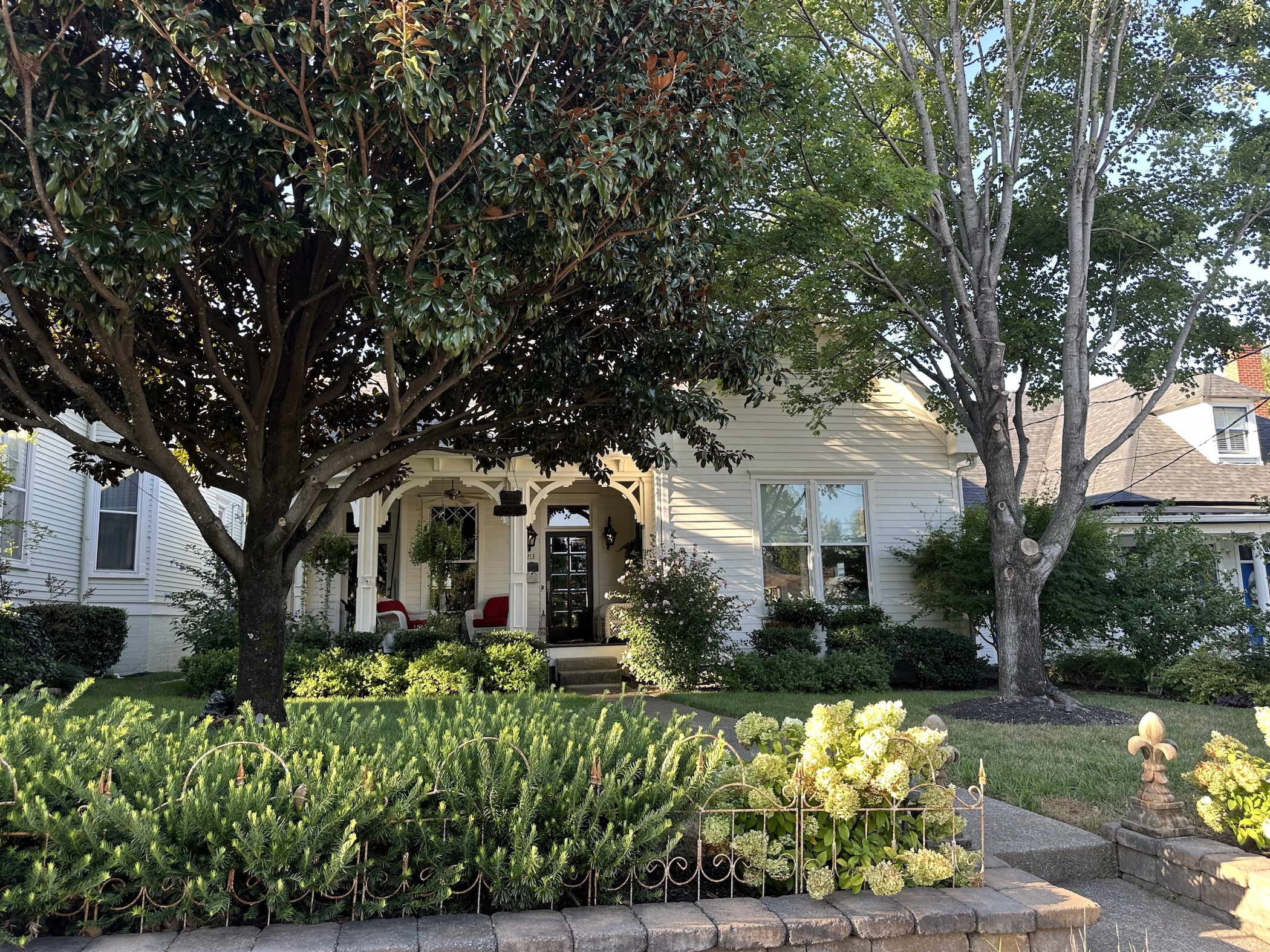 An old house with a beautiful yard and plants