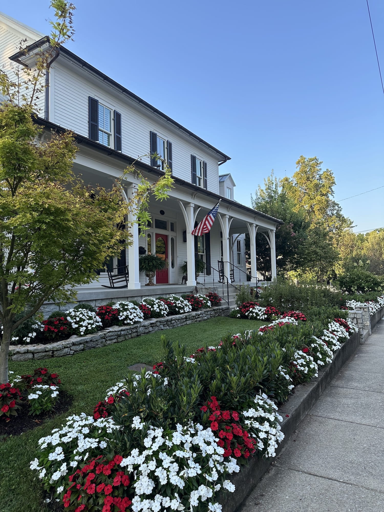 A beautiful white house with flowers