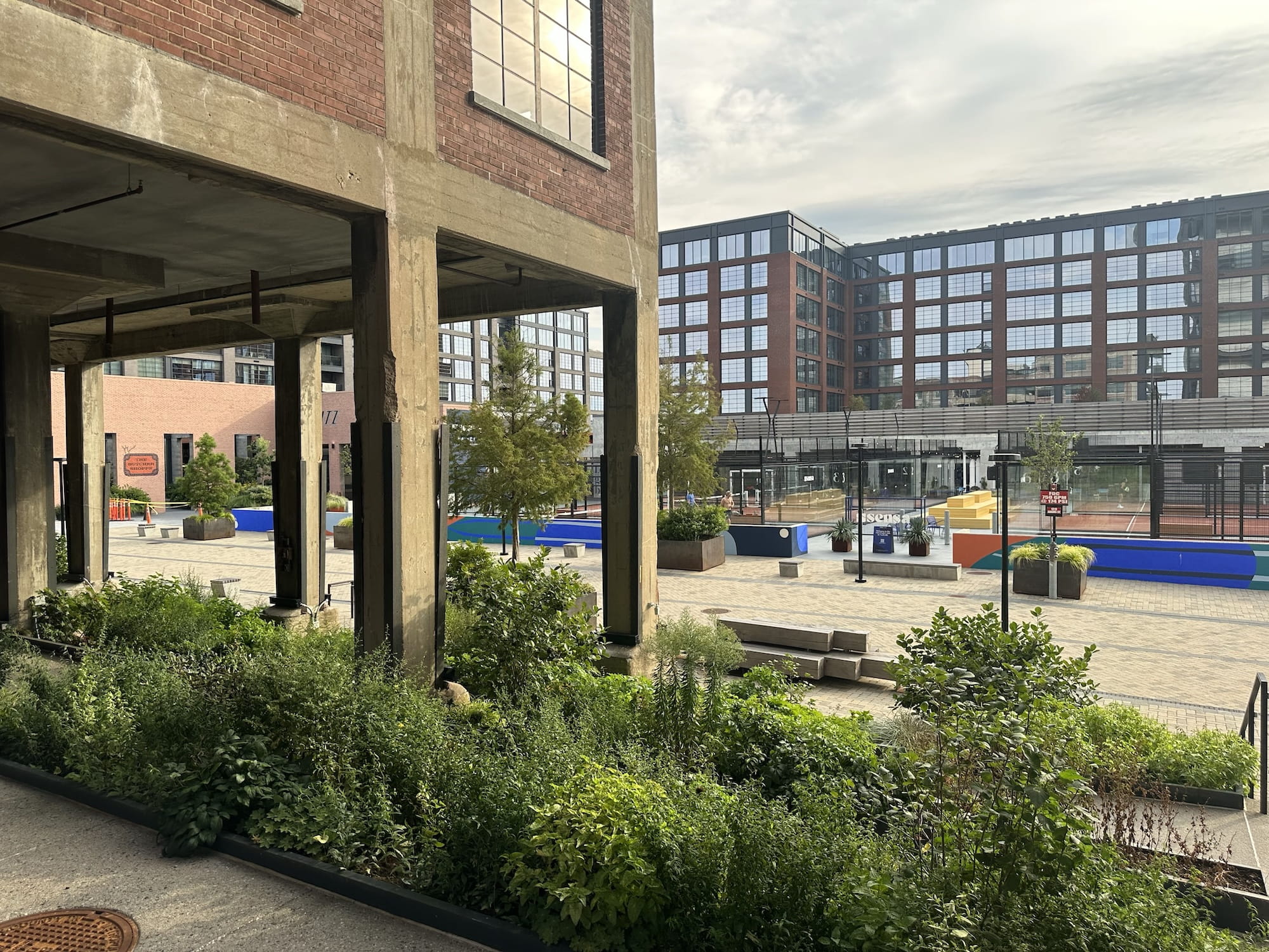 Padel courts, an industrial building, stairs and flowers