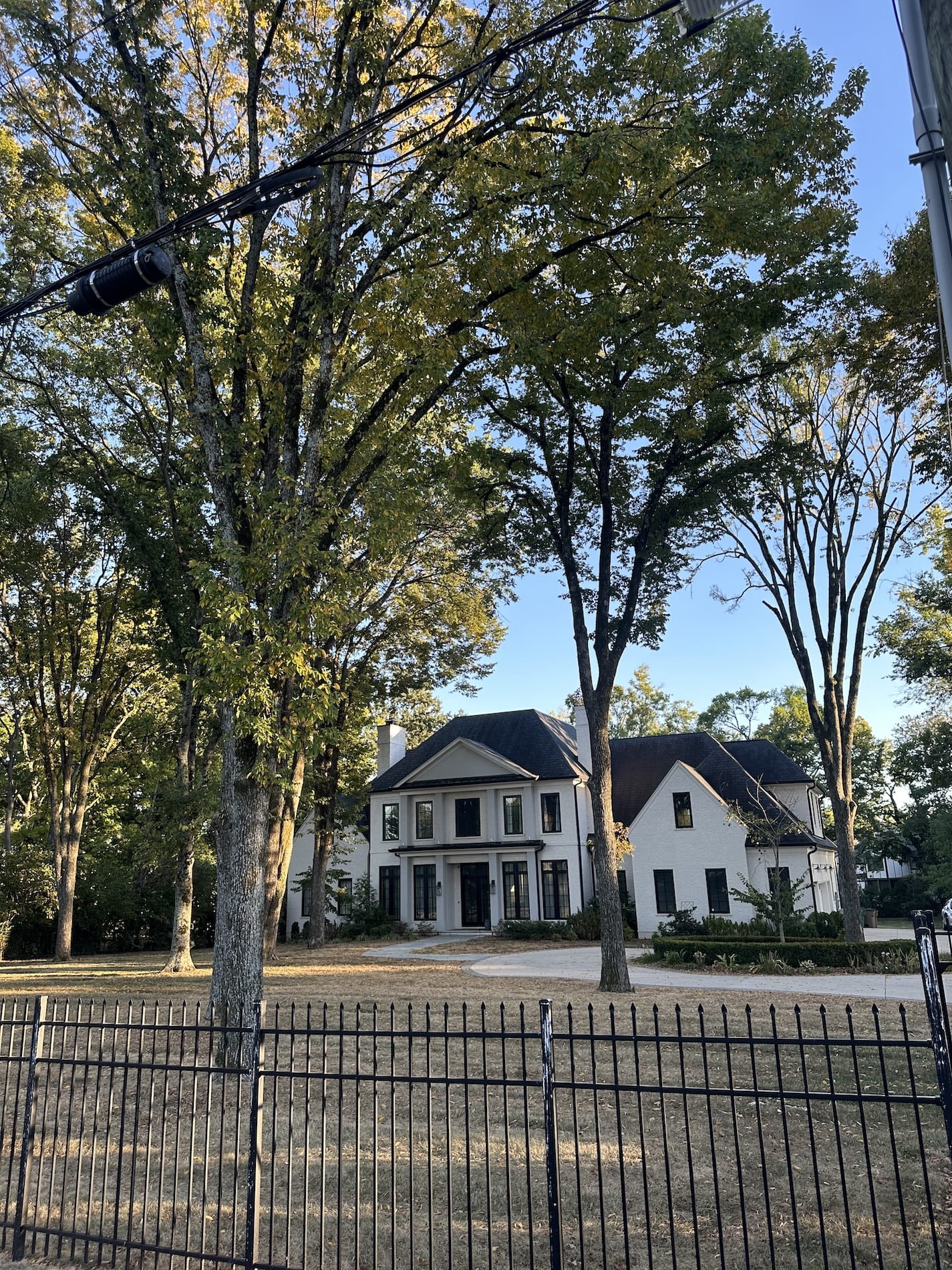 A stunning mansion with an iron fence