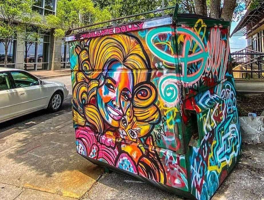 A dumpster with Dolly artwork