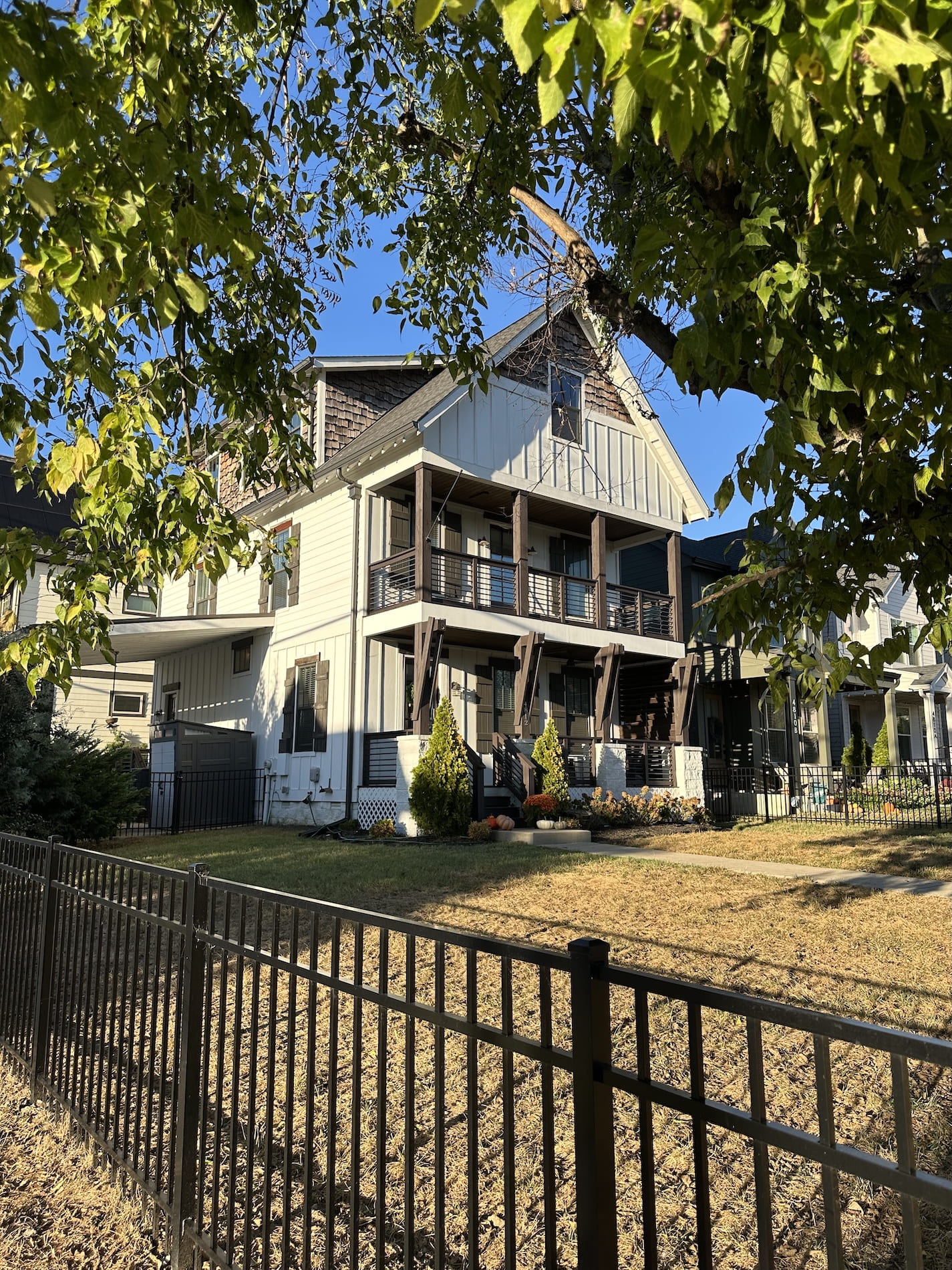 A big house with a fence and a yard