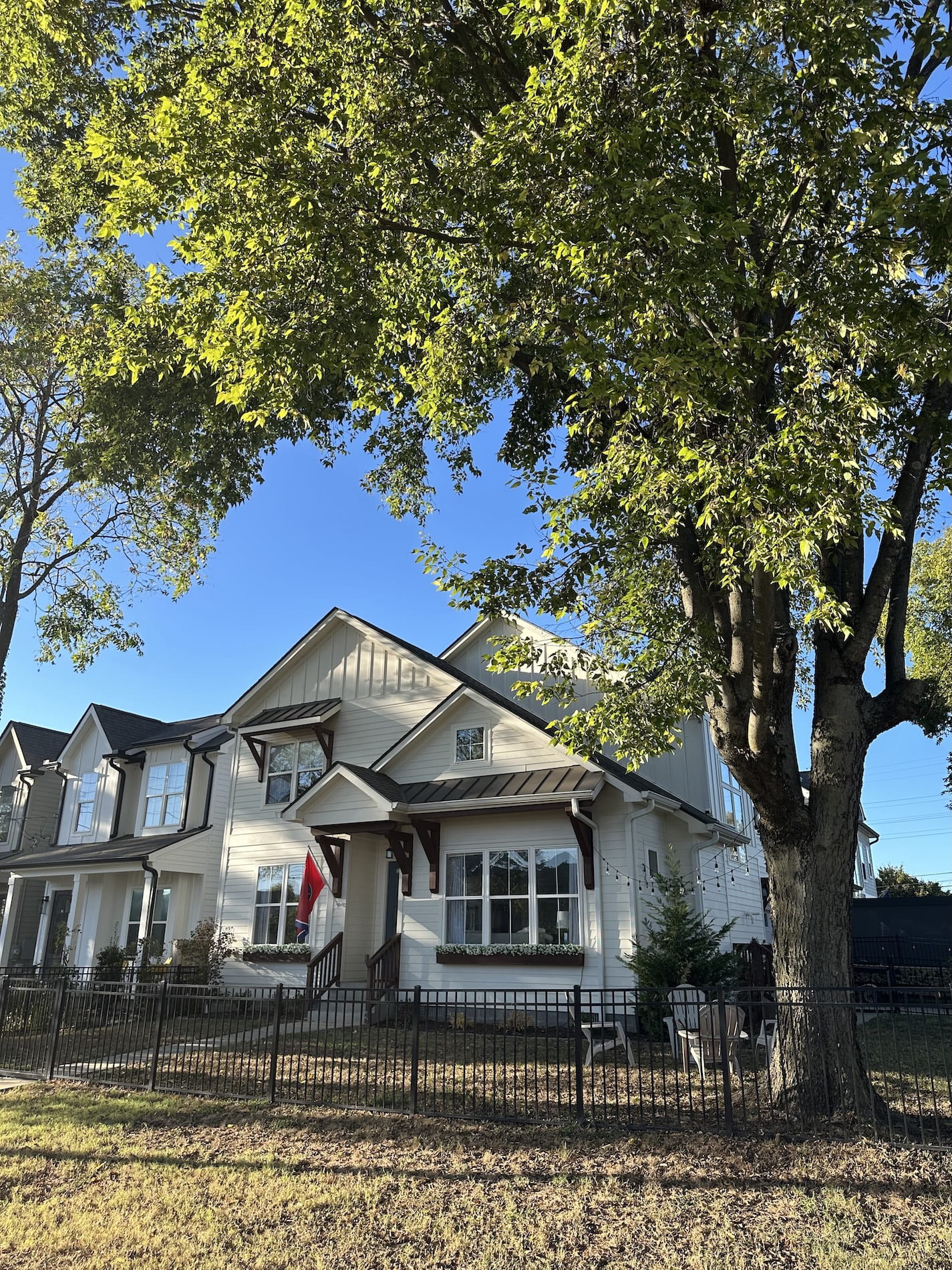A white house with a big tree