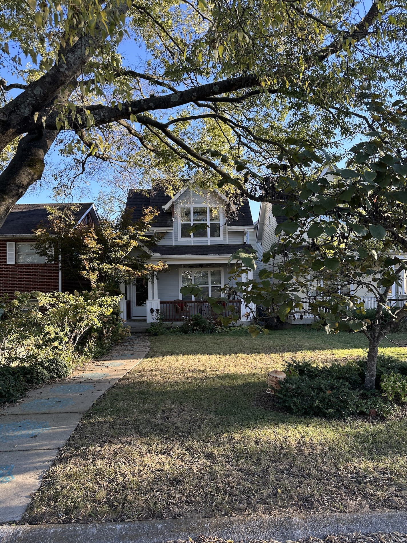 A white house with a pathway to front door