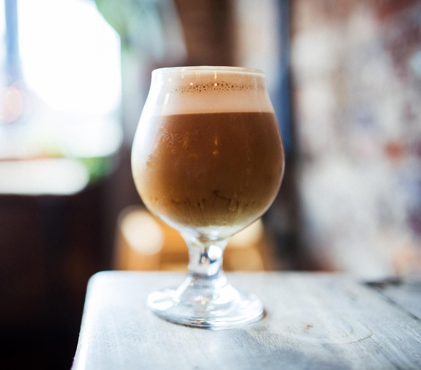 A cold foam coffee in a glass