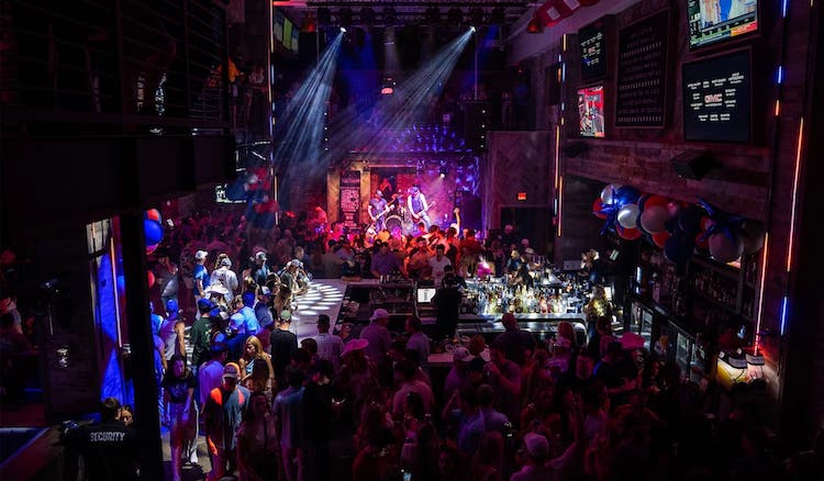 A band playing inside Barstool with lots of people there