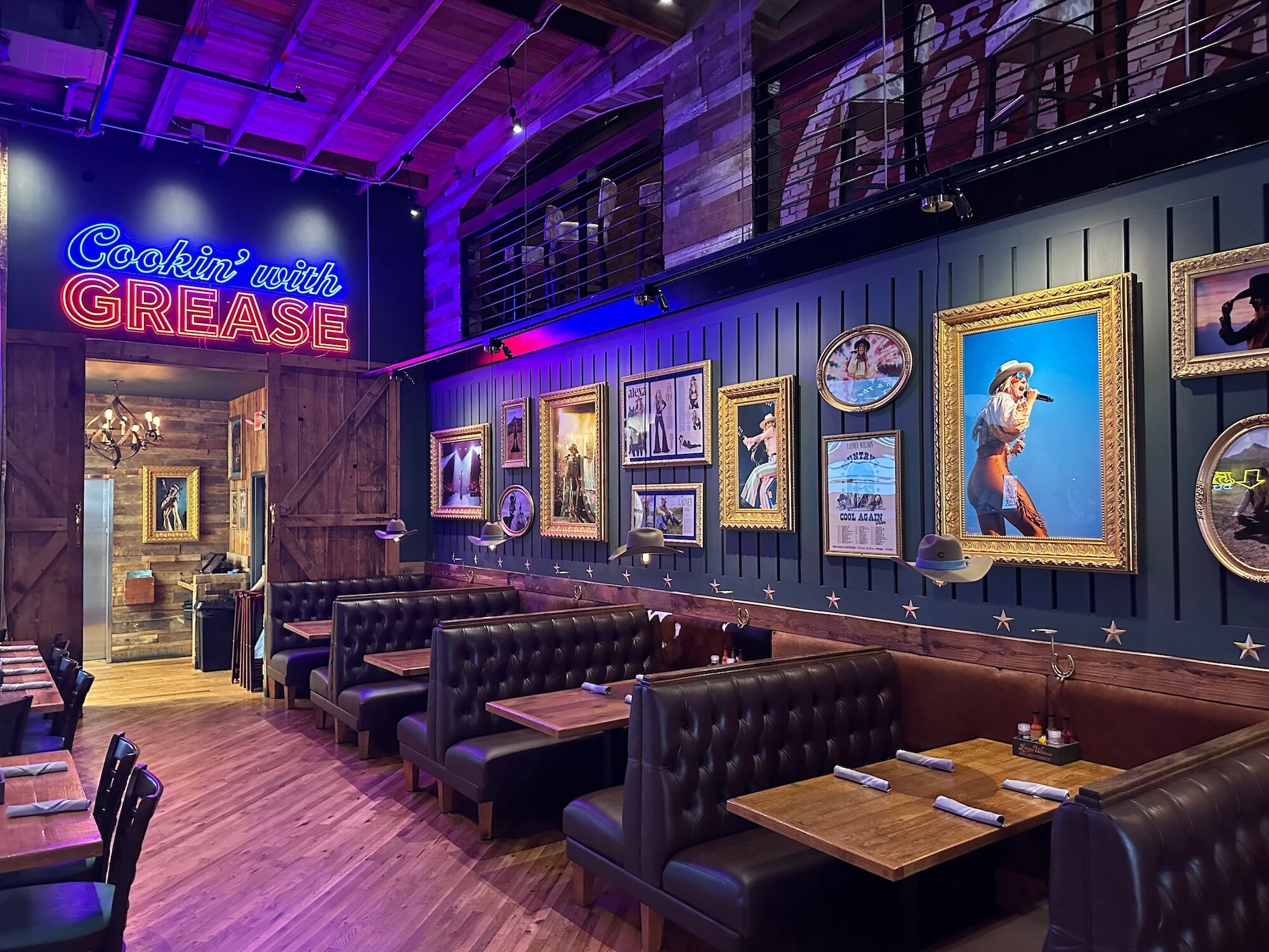 Tables and booths inside a country themed bar