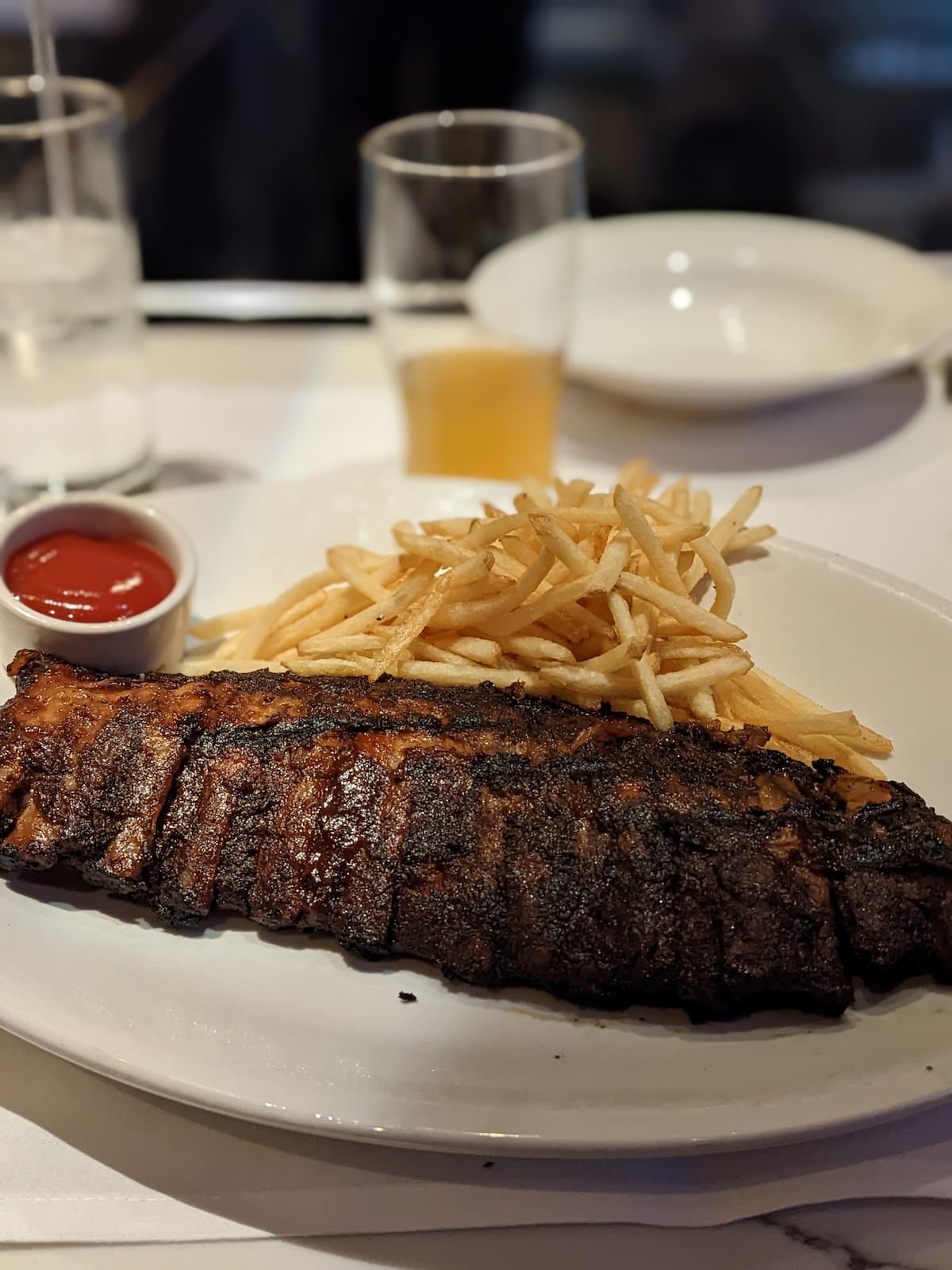 A plate of ribs and fries