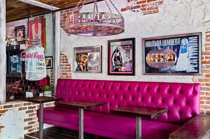 A pink couch at a bar