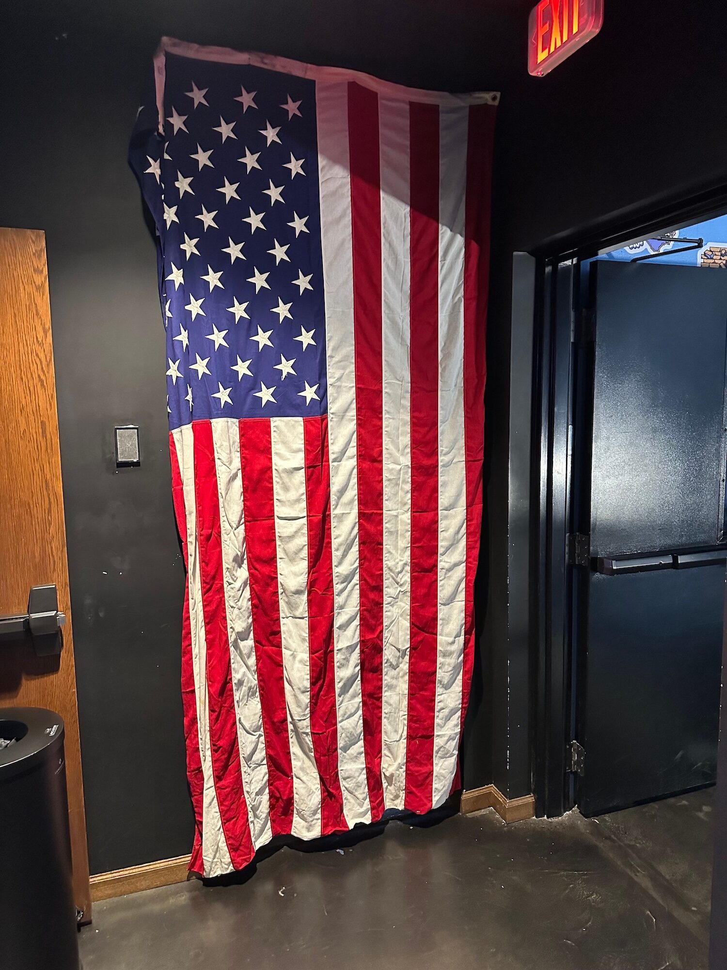 An American flag hanging by a door