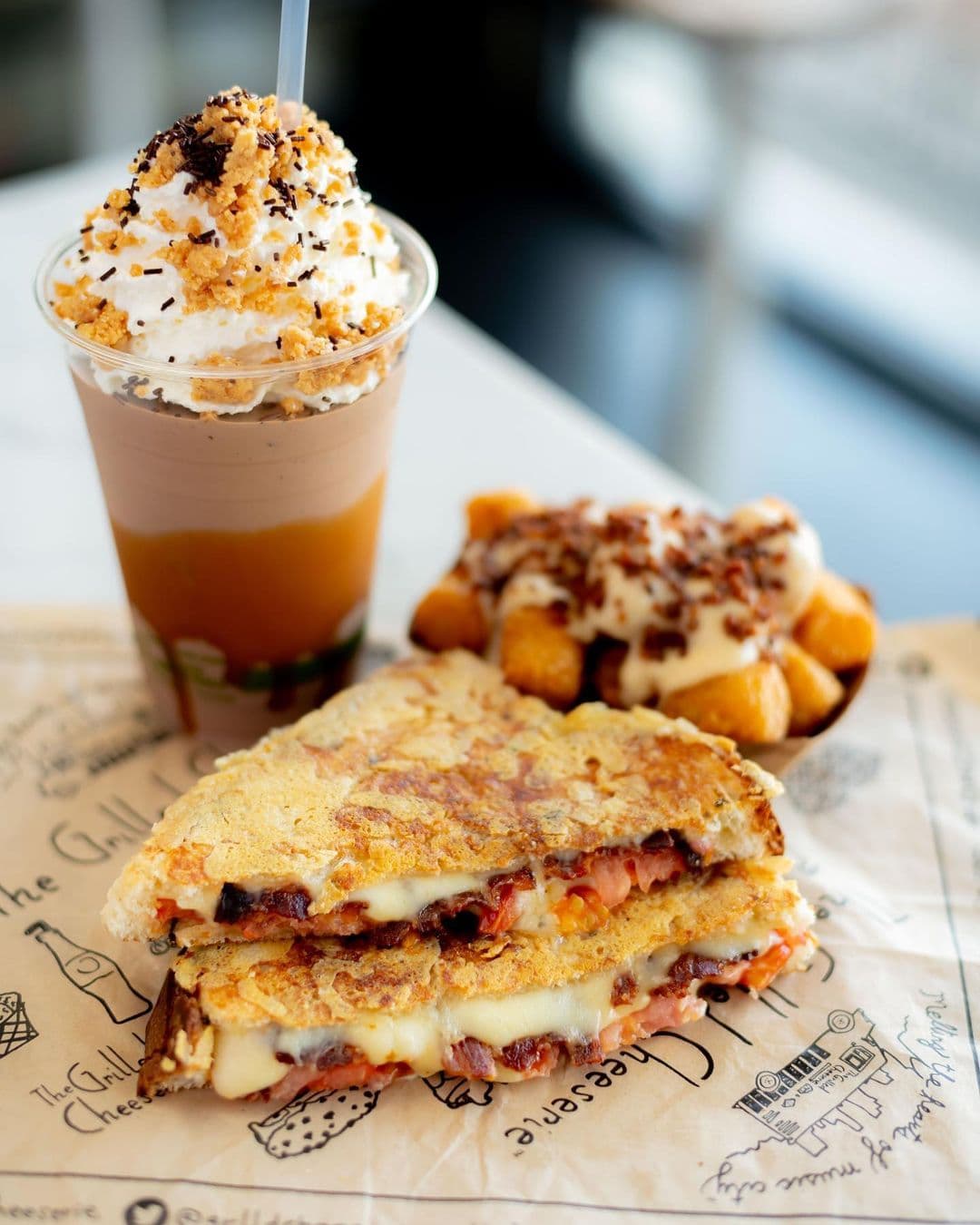 Grilled Cheeserie sandwich, shake and tots