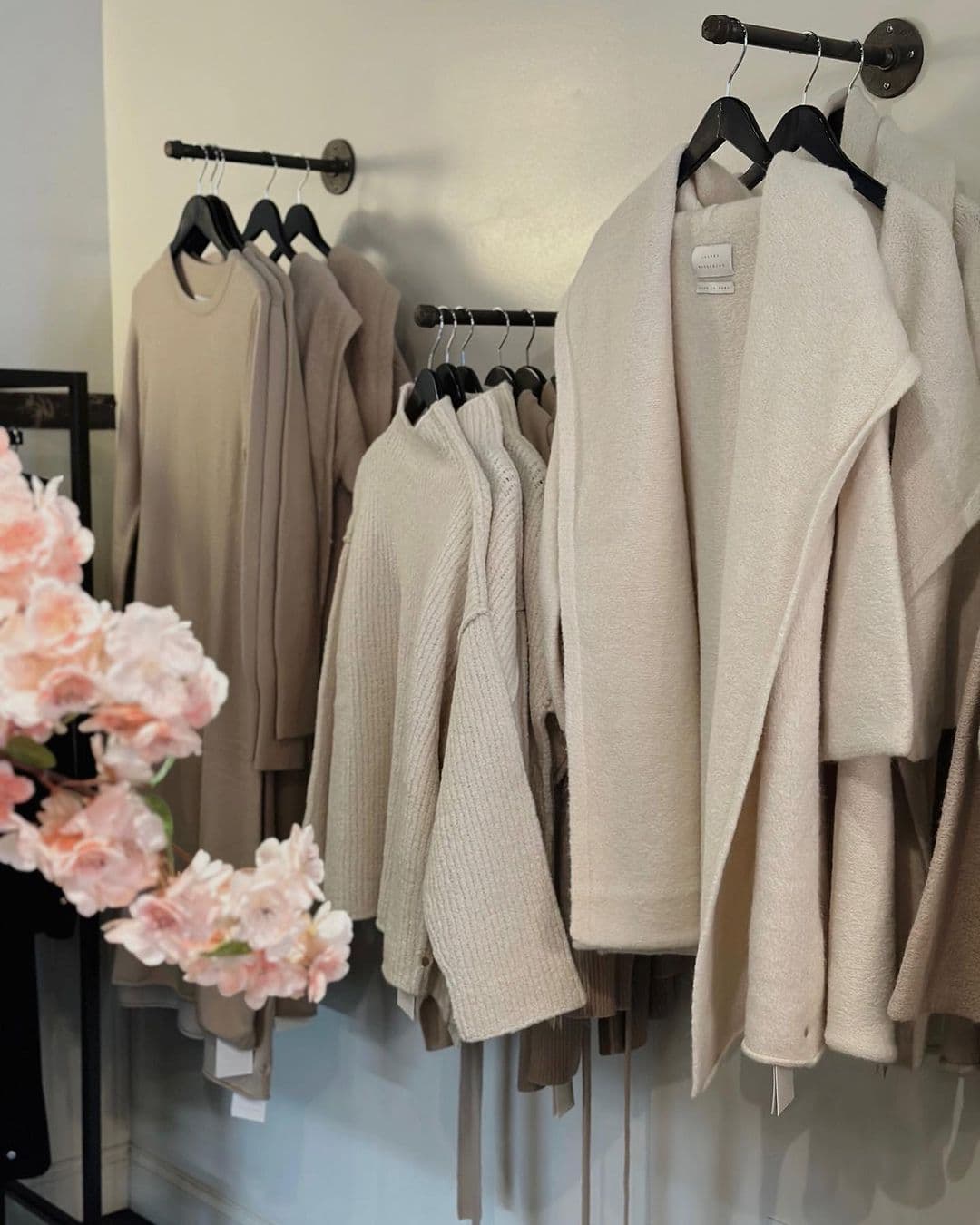 Sweaters hanging on a wall