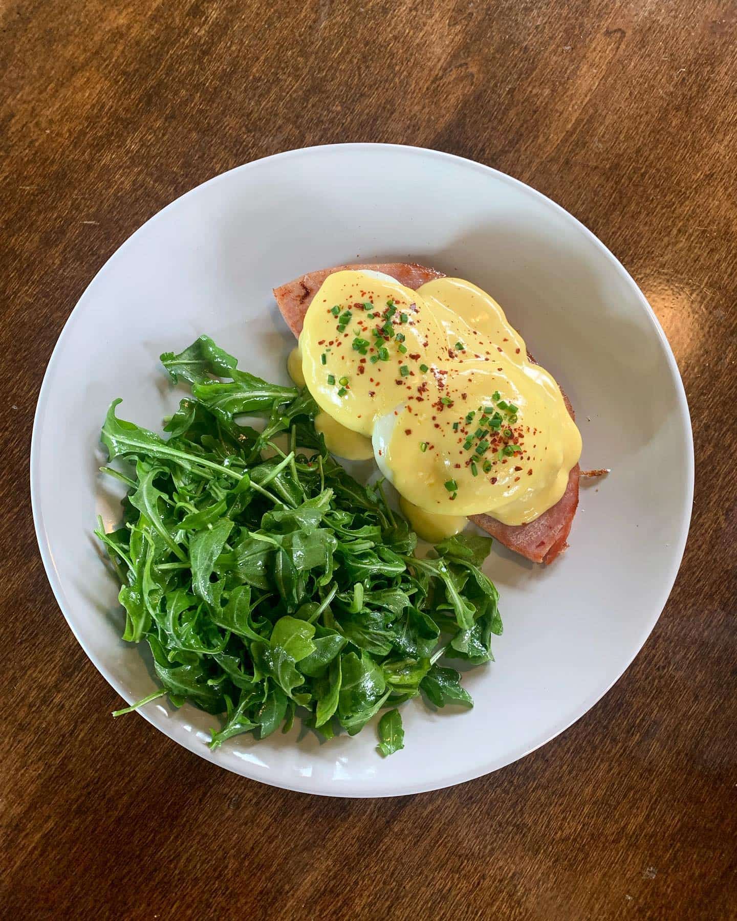 Eggs benedict on a white plate