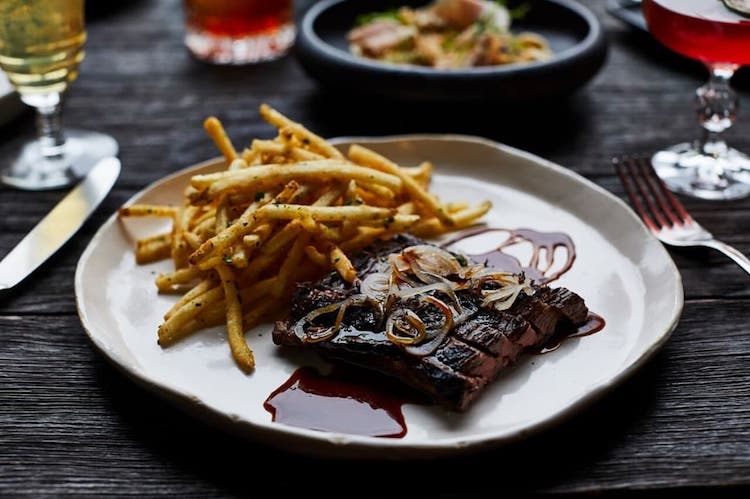 A plate of steak and fries