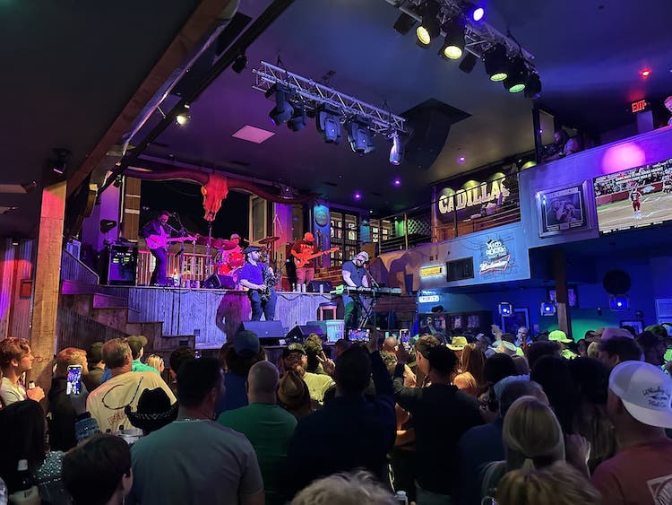Kid Rock's guy playing a sax solo on stage and lots of people