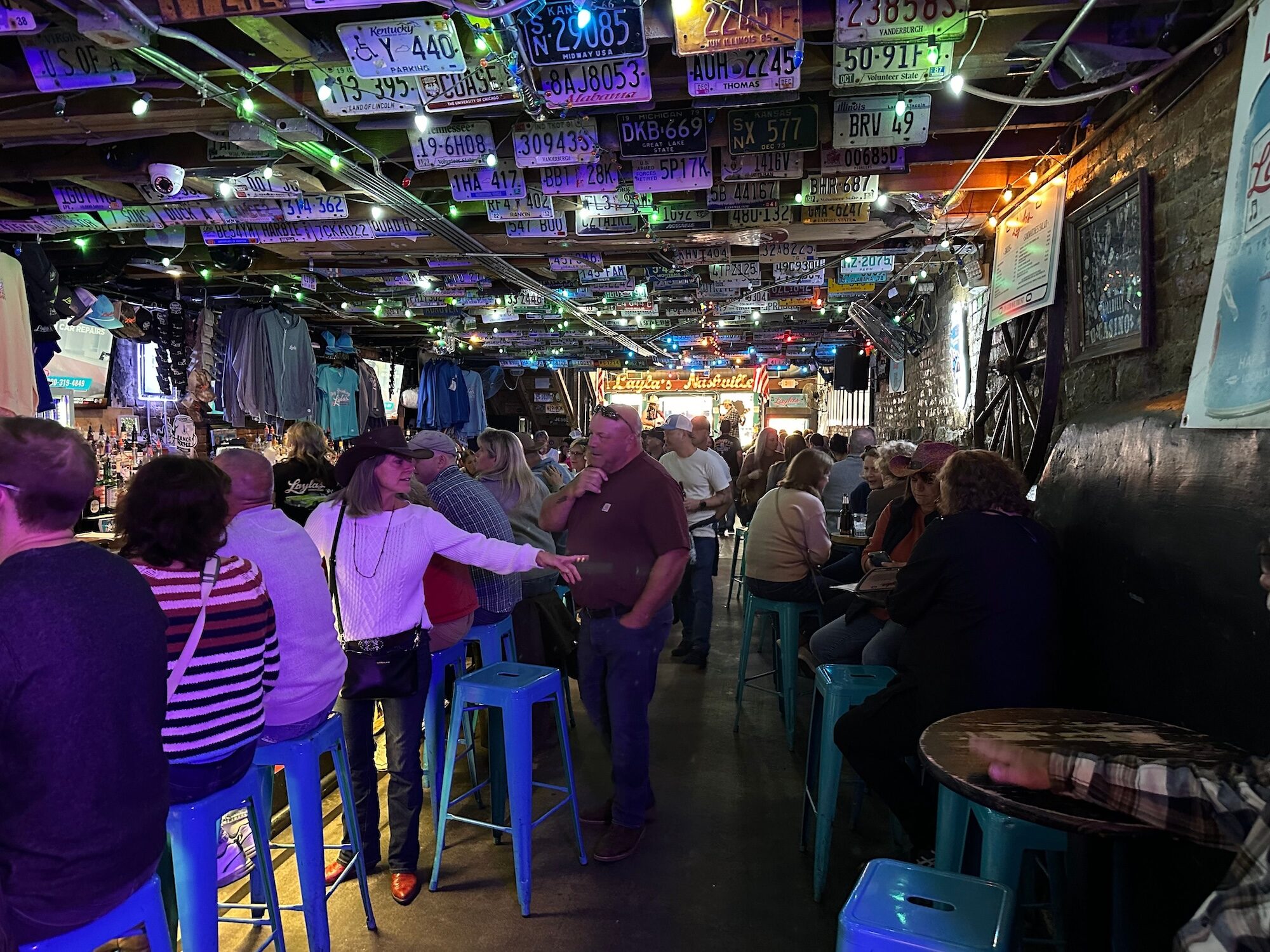 People at a wooder bar on Broadway