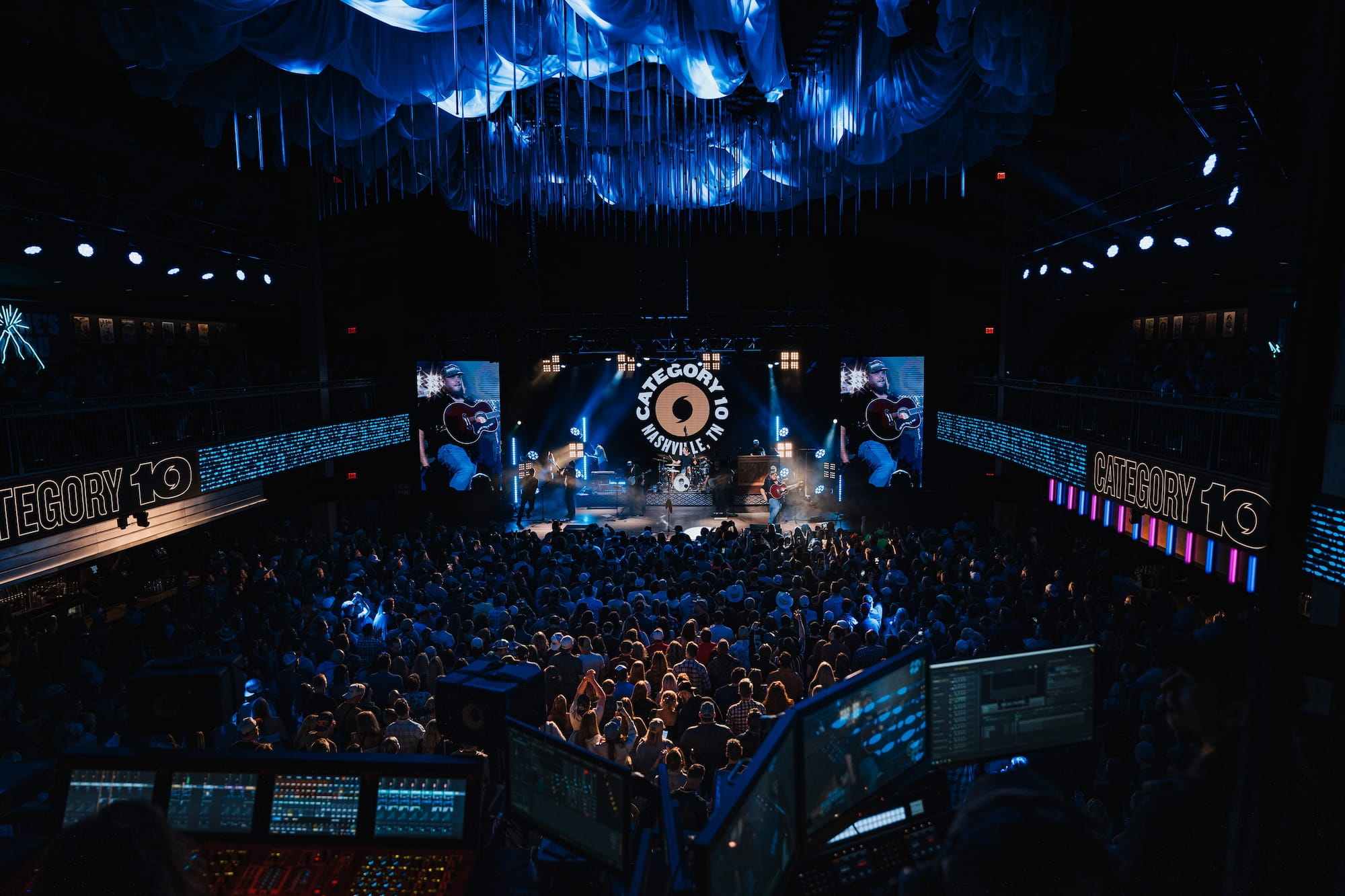 A crowd watches a show inside Category 10