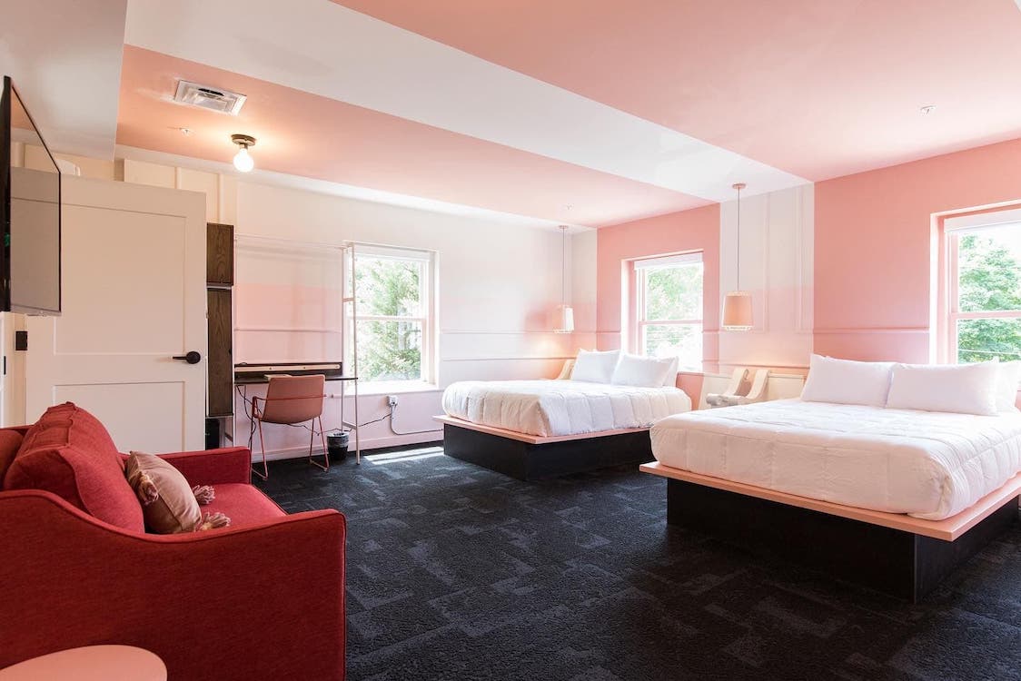 A pink bedroom with double beds