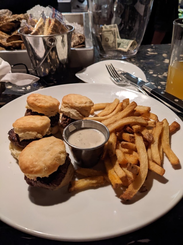 Steak sandwiches on a plate with fries